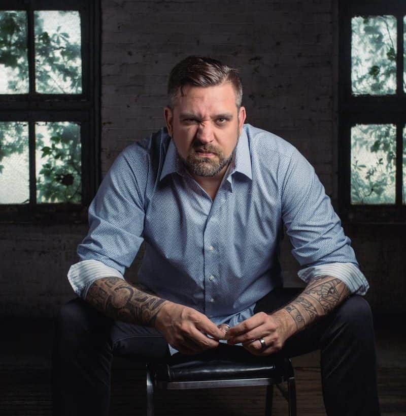 Man Sitting on Black Leather Padded Chair