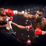 FILE - In this Nov. 22, 1986, file photo, Mike Tyson, right, delivers a blow to Trevor Berbick during a boxing bout in Las Vegas. Organizers say seven boxers and 12 others will be the first inductees at the new Nevada Boxing Hall of Fame in Las Vegas. Inductees to be enshrined Saturday, Aug. 10, 2013, in the inaugural class include boxers Tyson, Larry Holmes, Sugar Ray Leonard, Julio Cesar Chavez, Mike McCallum, Diego Corrales and Oscar De La Hoya. (AP Photo/Douglas C. Pizac, File)